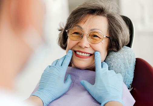 Dentist looking at patient's smile in treatment chair