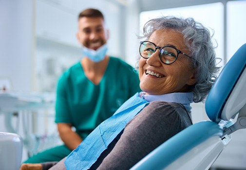 Woman smiling while sitting in treatment chair