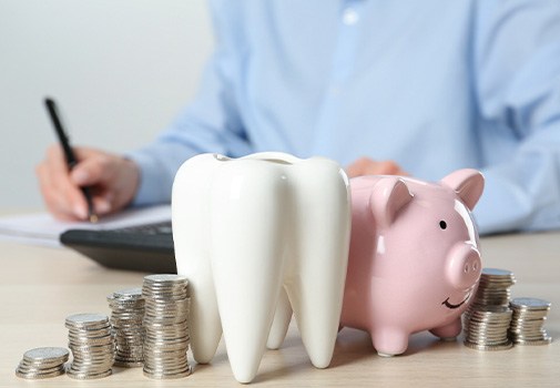Coins next to a piggy bank