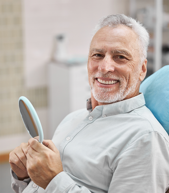 Smiling senior man visiting an oral surgery office in Medford
