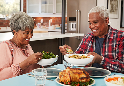 Senior couple eating dinner at home
