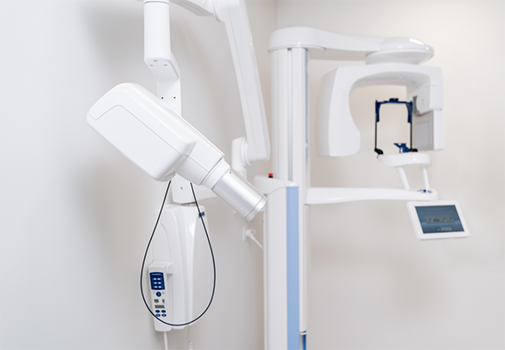 CT cone beam scanner standing against a wall