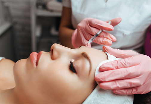 Woman getting an injection near her eyebrow