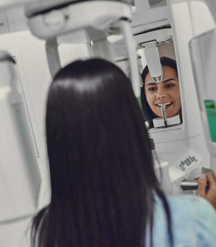 Woman getting a cone beam CT scan of her mouth and jaws