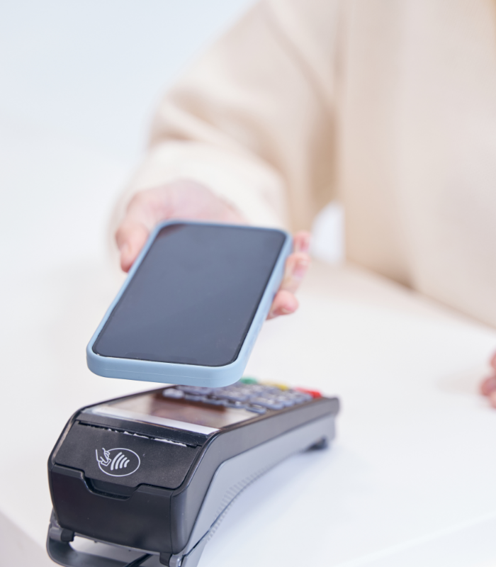 Person using their phone to pay for oral surgery treatment