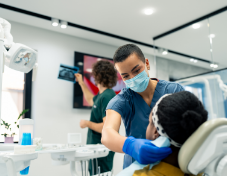 Oral surgeon preparing a patient for a procedure