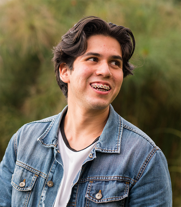 Smiling young man with traditional braces