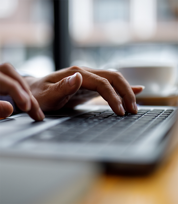 Person typing on a laptop to request an oral surgery appointment in Medford